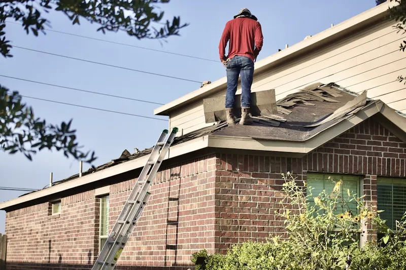 Professional roofer working on a residential roof in Grady Heights